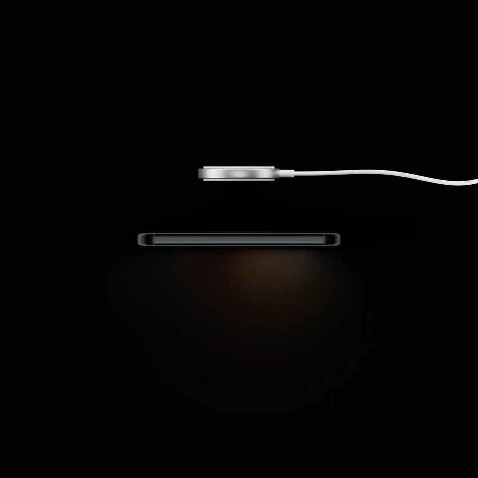 OneKey Pro 2 charging on a wireless charging pad